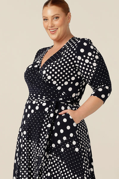 A jersey wrap dress with navy and white polka dot print, this is a great workwear and event wear dress. Featuring 3/4 sleeves and a full, below-the-knee length skirt, this wrap dress is Australian-made and looks stylish on plus size and fuller figure women.
