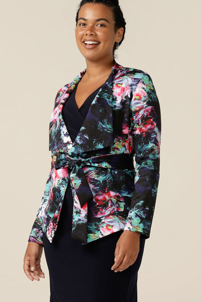 A wrap front jacket in abstract floral print is worn with a navy blue wrap dress as an event and occasionwear jacket. Made in Australia, shop with free shipping to New Zealand for a limited time only,