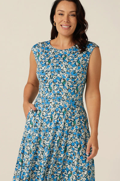 high-neck sleeveless jersey dress with calf-length full skirt and pockets