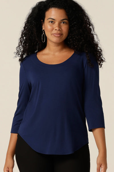 a curvy size 12 woman wears a french navy bamboo jersey top with a round neckline and 3/4 sleeves. Made in Australia in sustainable bamboo jersey, this casual women's top is lightweight, breathable and comfortable.