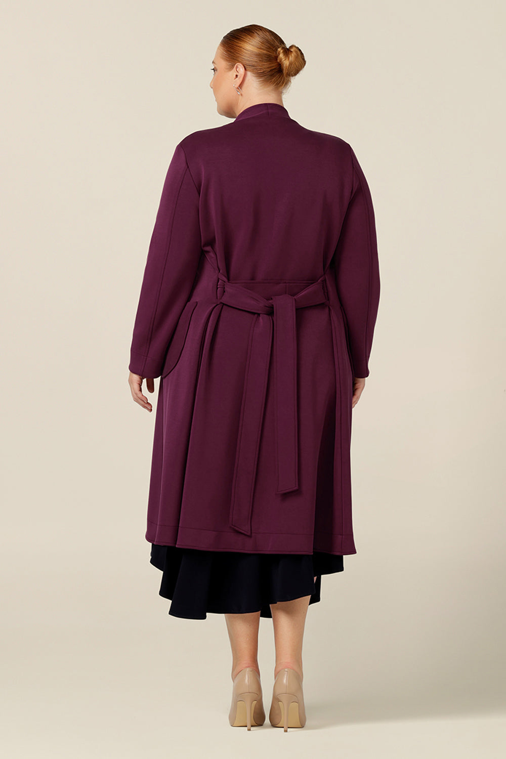 Back view of Australia and New Zealand women's clothing label, L&Fs best lightweight coat for winter. In wine red Modal, this women's coat has stretch for comfortable wear over workwear and corporate suiting, making it a great coat for travelling that work day commute.