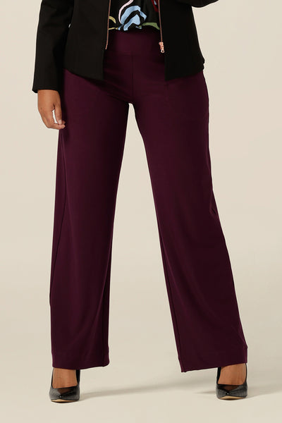 A close up of an Australian-made wide leg, full-length jersey trouser in Mulberry red. By Australian and New Zealand fashion brand, L&F these straight cut, wide leg pants promise to be a comfortable work wear trouser for sizes 8 to size 24. 