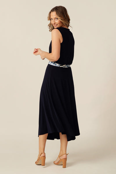 Sleeveless dress with cowl-neckline and asymmetrical skirt.
