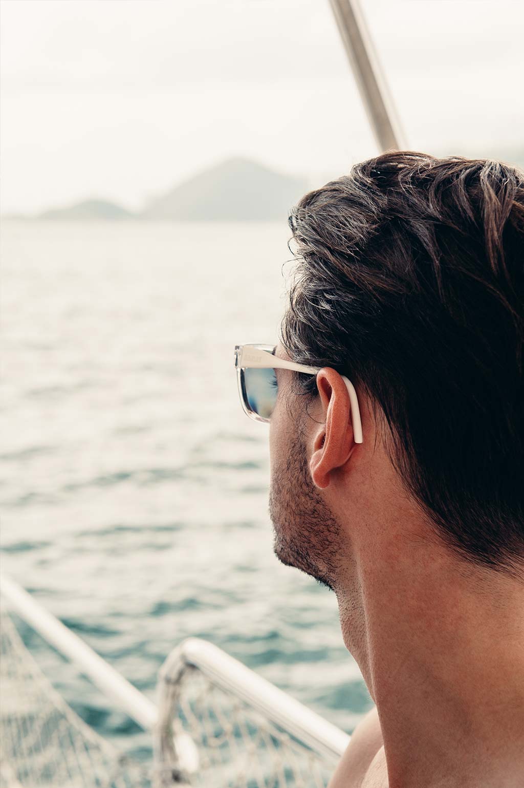 Male model wearing Baendit sunglasses on a boat