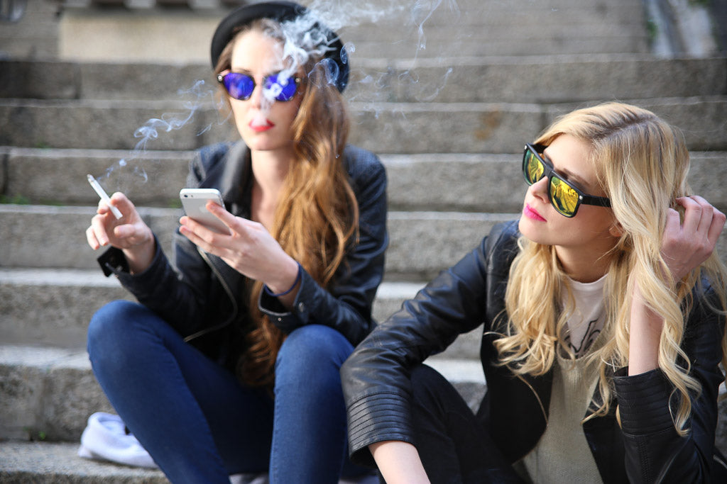 Baendit models wearing sunglasses smoking on stairs 