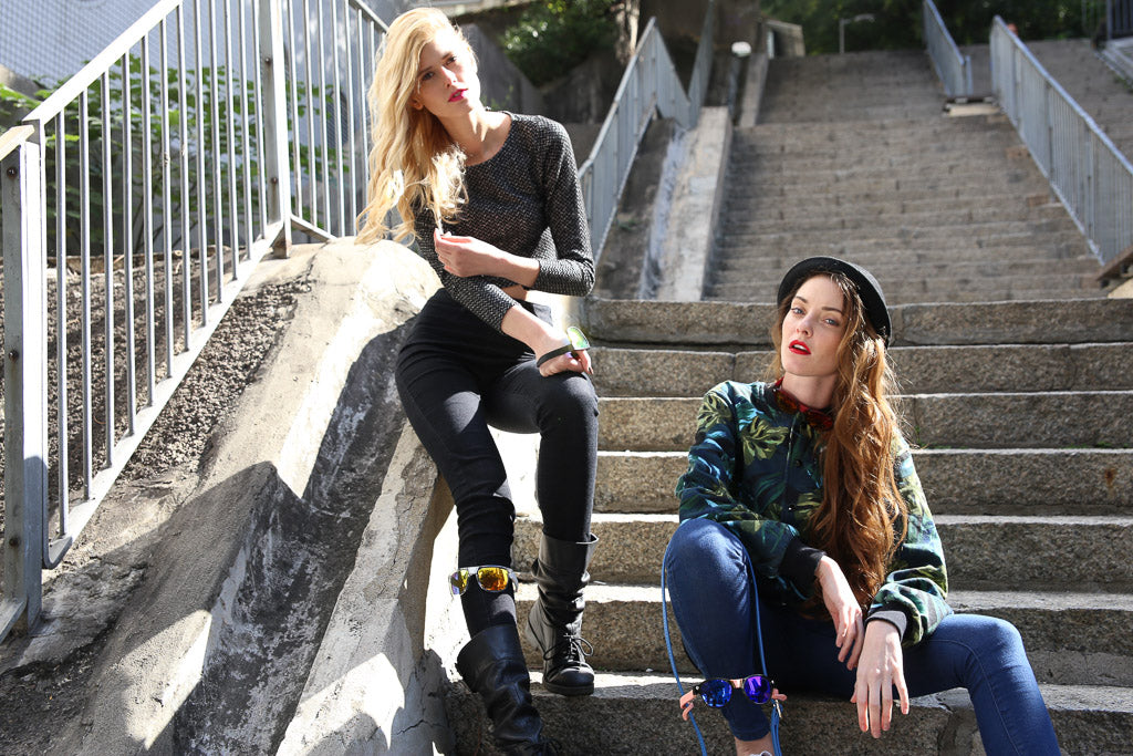 Two female models wearing Baendit sunglasses on stairs