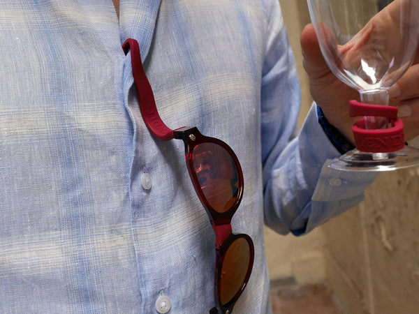 pair of red beandit sunglasses hanging from a shirt