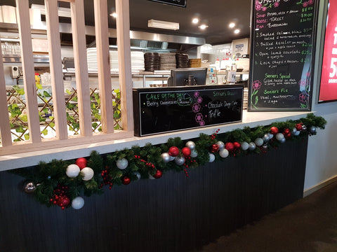 Christmas garland with glass ball ornaments along lunchbar counter