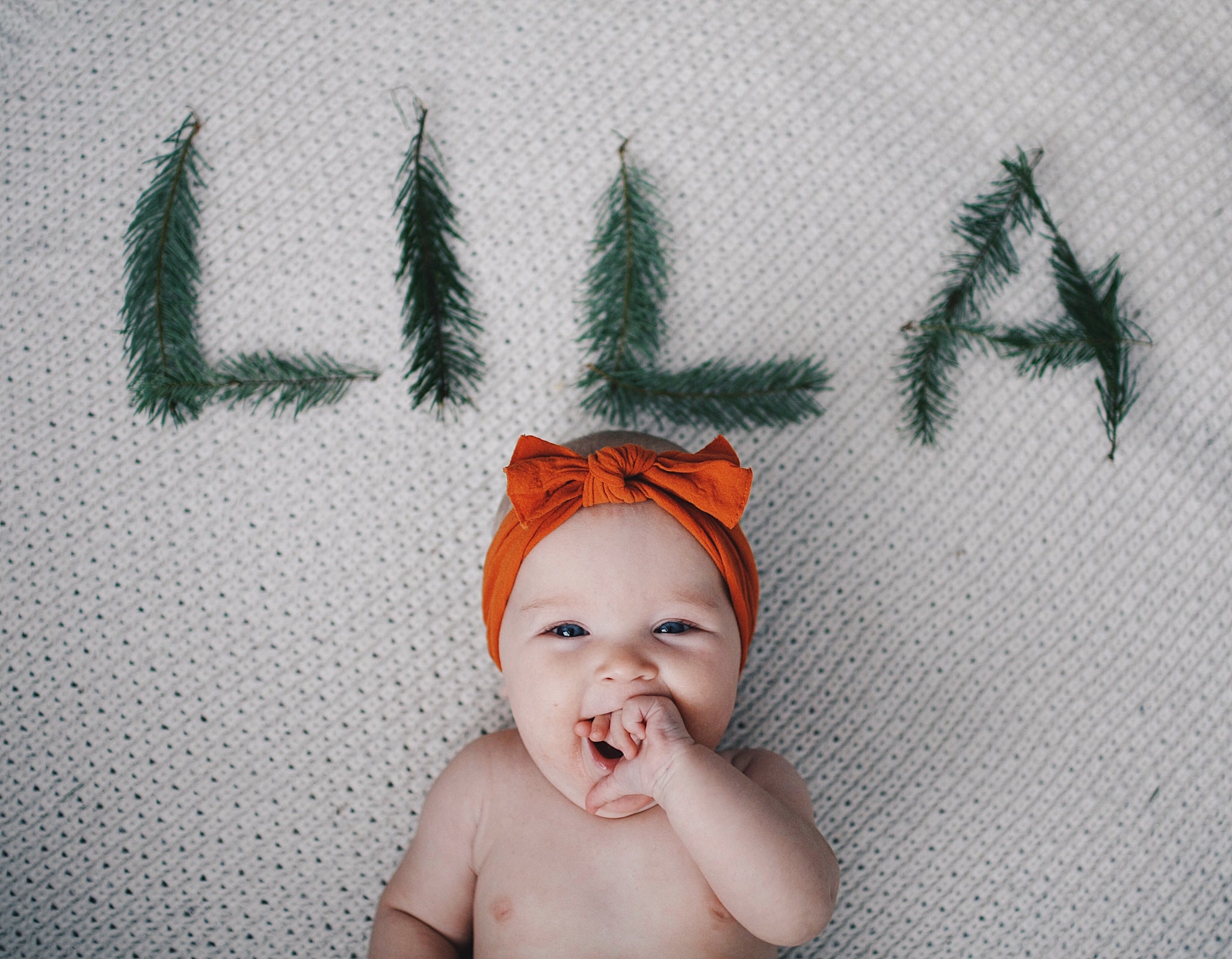 Newborn baby girl happily smiling