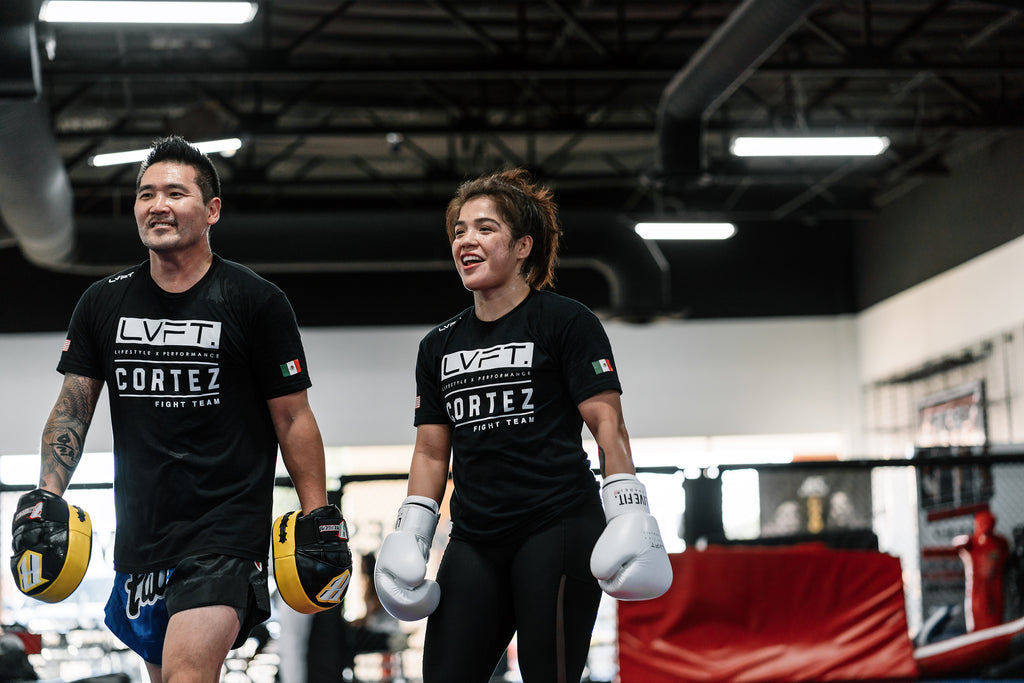 Striking coach Eddie Cha and fighter Tracy Cortez all smiles after a rigorous session.
