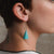 Michele Mockiuti: Blue Cone Earring on display.
