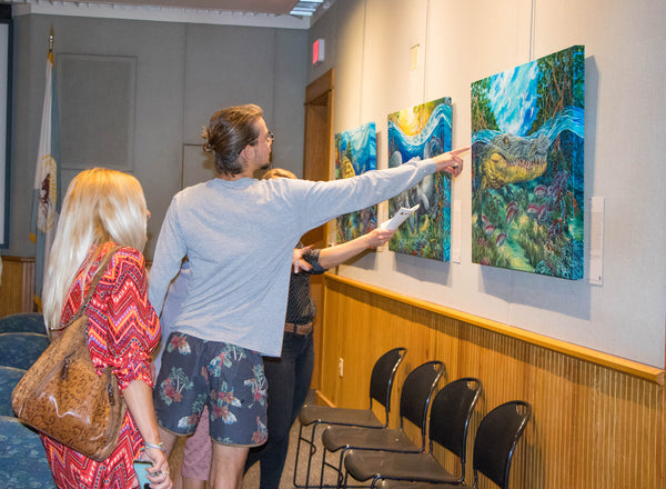 Guests viewing "Immersion" artwork at reception in Biscayne National Park   