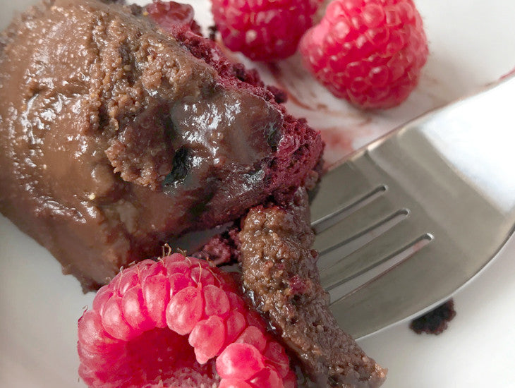 Paleo red velvet cake with chocolate frosting, close up with a fork.  Yummy!