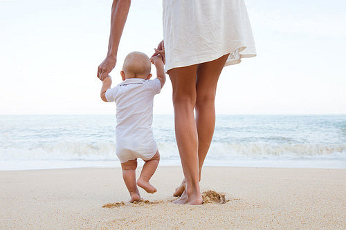 mother and son walking on beach