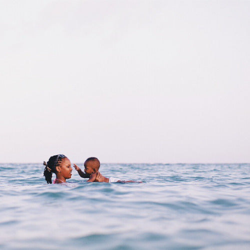 mother and son swimming ocean