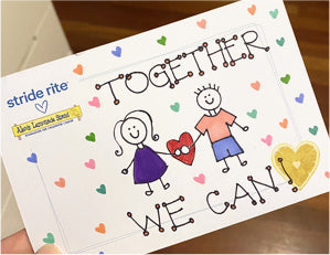 Drawing with the words 'Together we can' and drawing of 2 kids holding hands with hearts in the background.