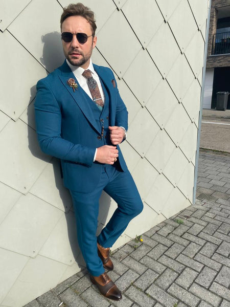 navy blue suit with turquoise tie