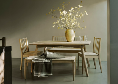 neptune dining table and chairs shown in a traditional, neutral dining room