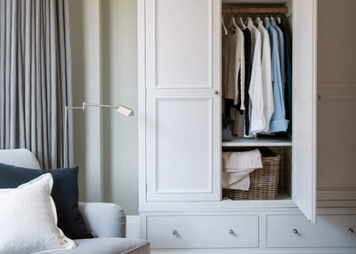 neptune wardrobe opened showing clothing in a modern bedroom