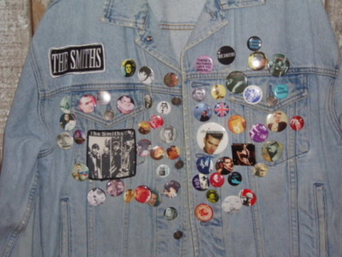 Denim jacket with badges and pins