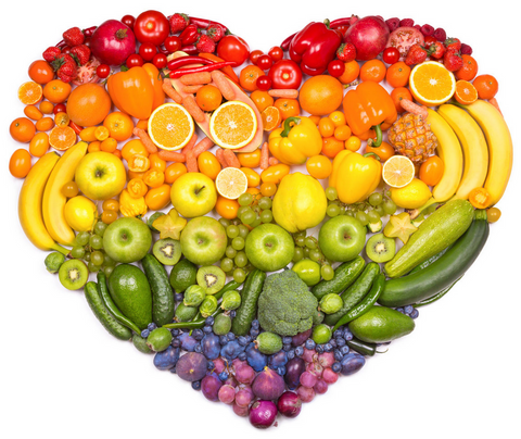 Different fruit and veggies laid out in a heart shape