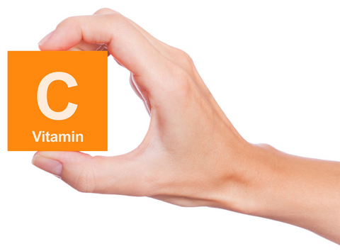 Person holding block labeled "Vitamin C"