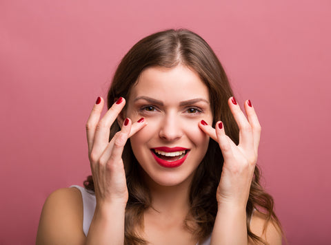 Women touching her under eyes 