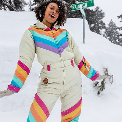 shop ski and snow suits - woman wearing retro rainbow snow suit