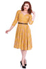 Timeless London yellow Kacee swing dress features a yellow orange black tartan print, with black belt on fitted waist. With wrap over feature, wide V-neck and flared swing skirt below the knee. Made sustainably.