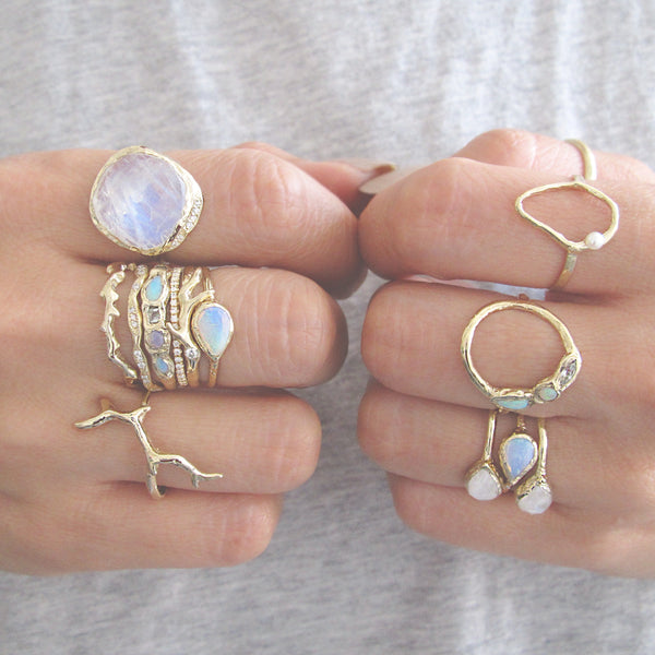 Handcrafted yellow gold ring collection on model's hand 