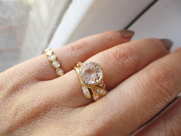 2 handcrafted morganite rings on model's hand 