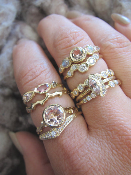 yellow gold and morganite gemstone rings on model's hand 