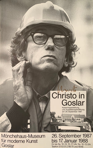 Black and white portrait of artist Christo in a hardhat with a pensive look. Small picture in the corner showing the museum. Gallery dates listed at the bottom.