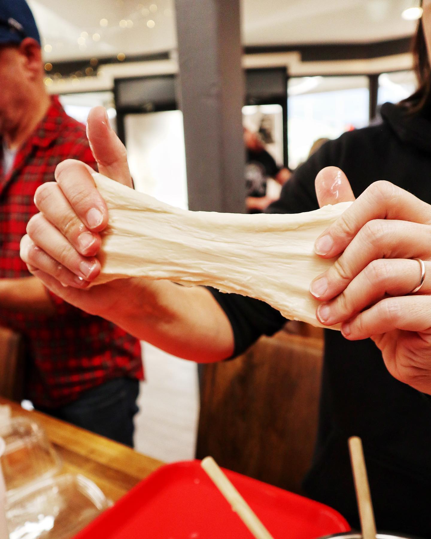 person pulling cheese while at a private event at River Valley Cheese