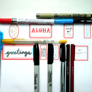 Group shot of labels with different writing utensils.