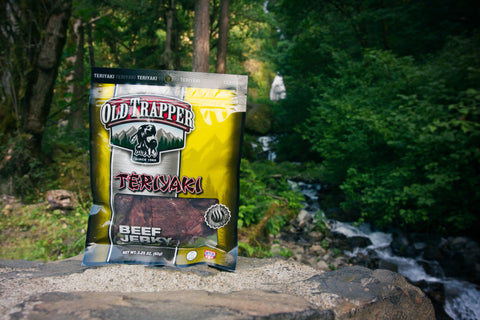 Old Trapper Teriyaki Beef Jerky bag in the forest