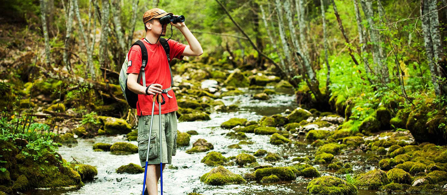 Man using binoculars in river