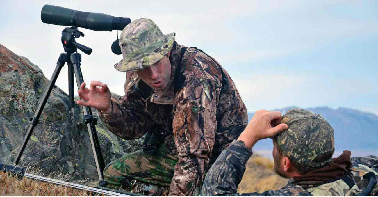 Men using spotting scopes in NZ