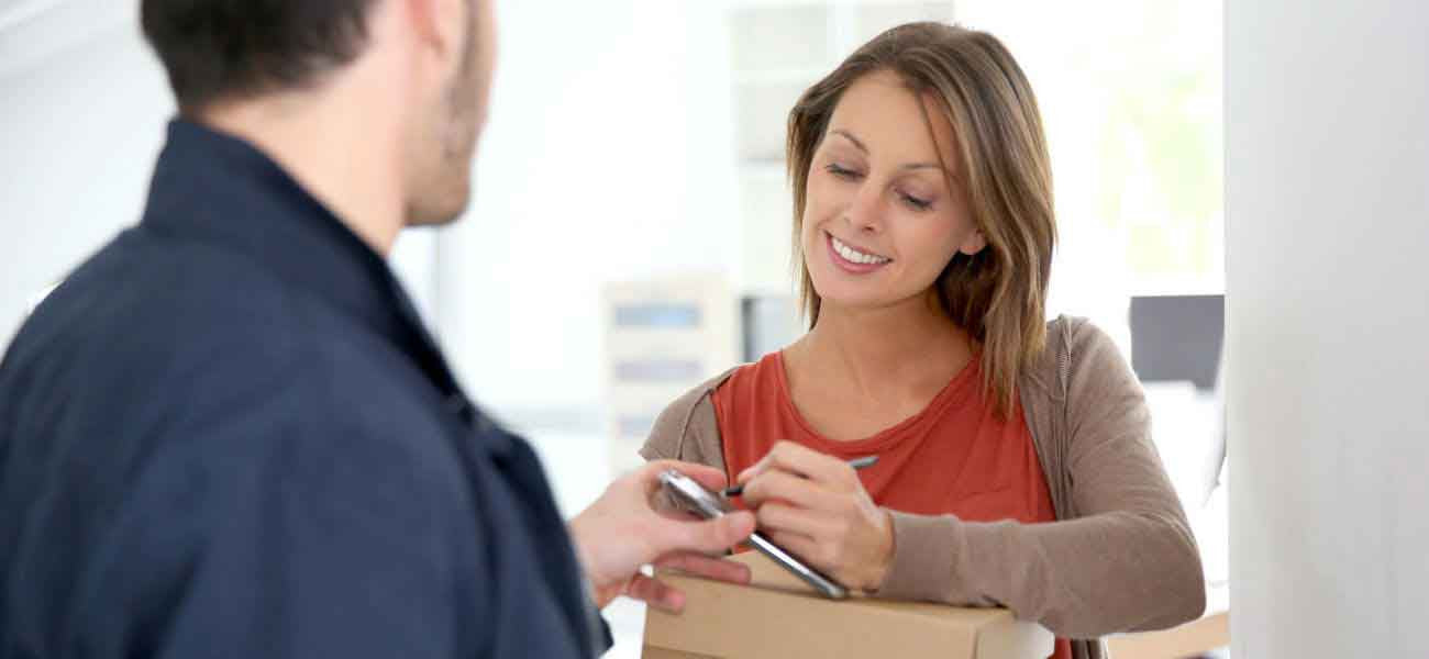 Woman signing for parcel