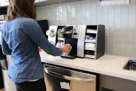 Woman using a Keurig Hot Drinks machine & Keurig coffee pods
