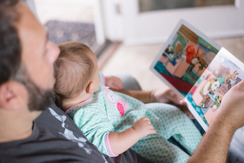 Dad reading to his baby