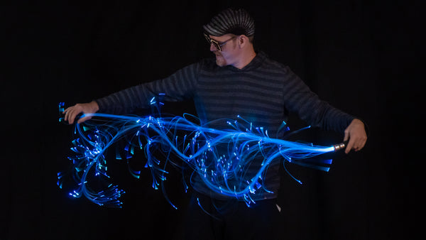 Jon is holding a vibrant, bright pixelwhip with a beautiful blue glow. It's the whip with the most fibers of them all!