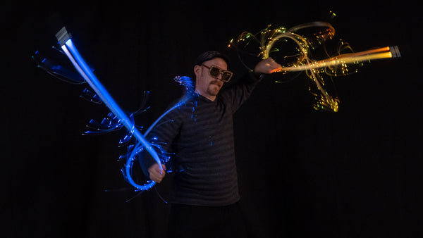 Alien Jon, a master poi spinner, shows off creative moves with two bright pixelwhips