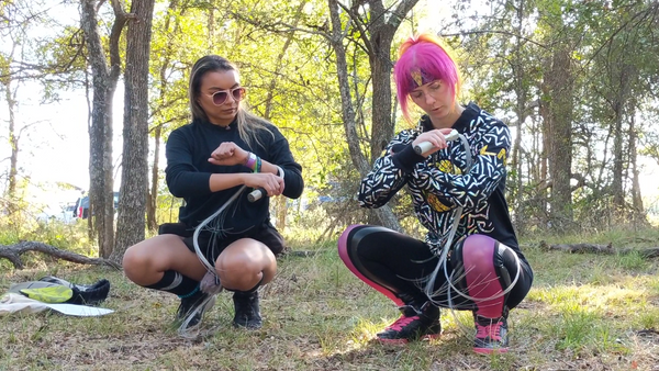 Fiber whip tutorial: Jacquelin (Firecat) showing Jasmine how to use an led whip in basic lacing technique