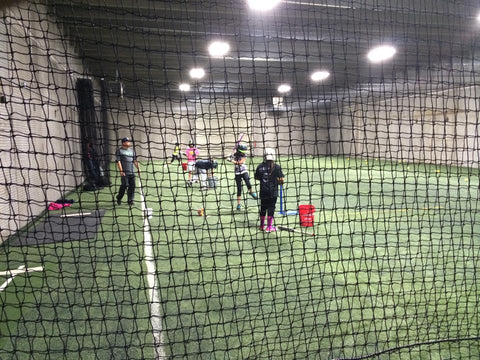 Team working in large room on fielding and hitting