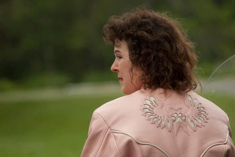 pink motorcycle jacket with white piping, crystal embellishments and with custom inlay design on back yolk