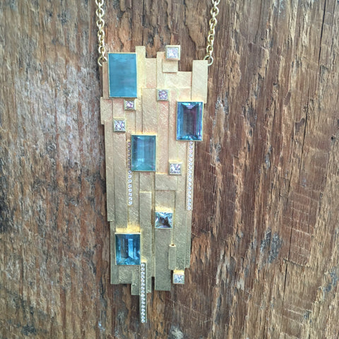 Todd Reed large yellow gold pendant with many aquamarines and diamonds.
