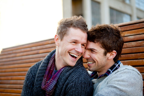 engagement photo with two men on a bench
