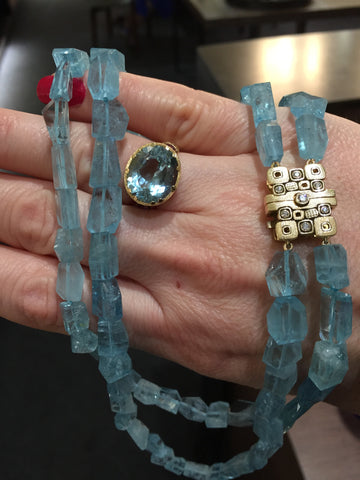 Sepkus 18k yellow gold ring and necklace with aquamarine gemstones.
