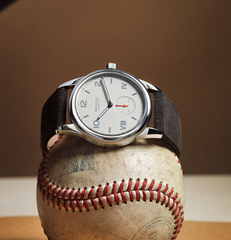 Nomos watch on top of a baseball